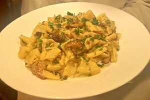 Chicken and pasta on a plate.